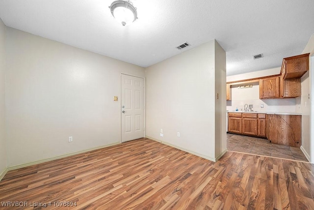 empty room featuring hardwood / wood-style flooring and sink