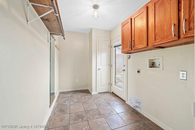 clothes washing area featuring cabinets, hookup for an electric dryer, tile patterned flooring, and hookup for a washing machine