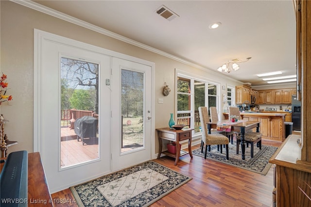 7441 Valley Creek Rd, Cecil, AR 72930 - dining area featuring plenty of natural light, visible vents, wood finished floors, and ornamental molding