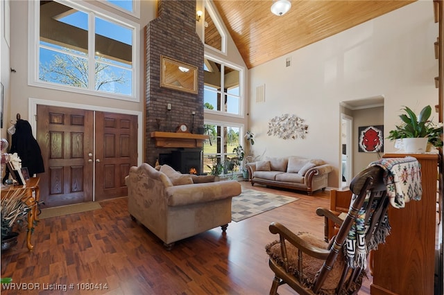 7441 Valley Creek Rd, Cecil, AR 72930 - living area with high vaulted ceiling, wood ceiling, wood finished floors, and a fireplace