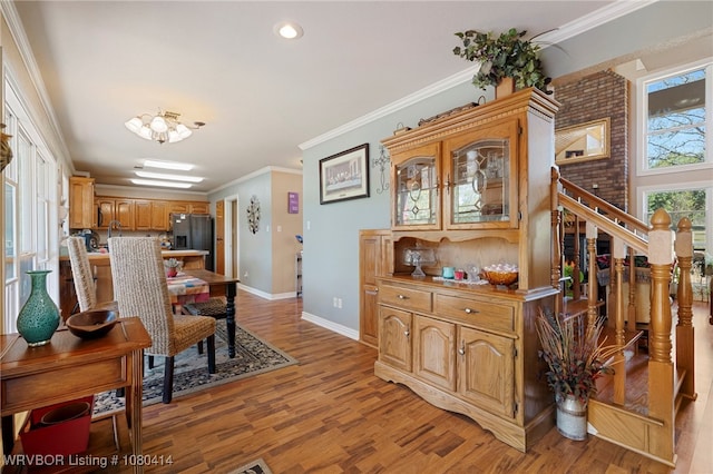 7441 Valley Creek Rd, Cecil, AR 72930 - dining room with stairway, light wood finished floors, baseboards, and ornamental molding