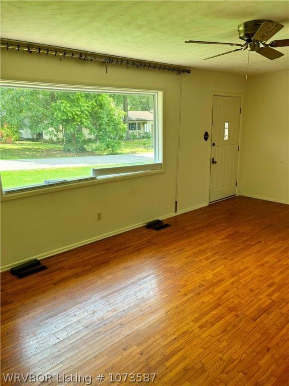 empty room featuring hardwood / wood-style flooring and ceiling fan