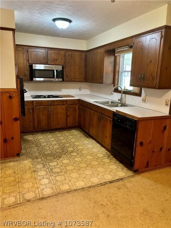 kitchen with sink, a textured ceiling, black dishwasher, dark brown cabinets, and stovetop