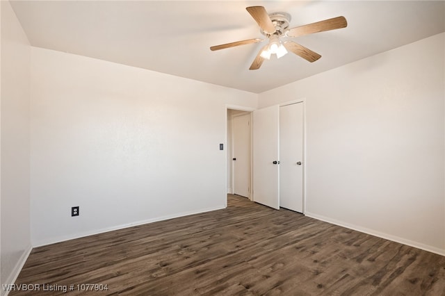 empty room with ceiling fan and dark wood-type flooring