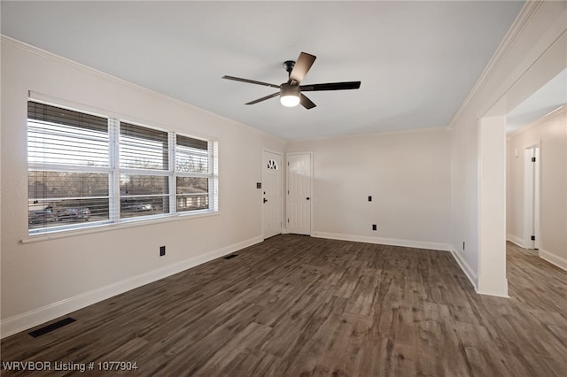 empty room featuring crown molding, dark hardwood / wood-style flooring, and ceiling fan