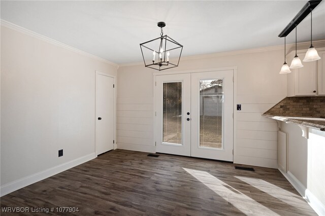 unfurnished dining area with french doors, dark hardwood / wood-style flooring, and ornamental molding