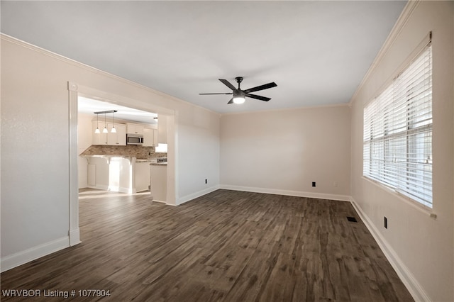 unfurnished living room with dark hardwood / wood-style floors, ceiling fan, and crown molding