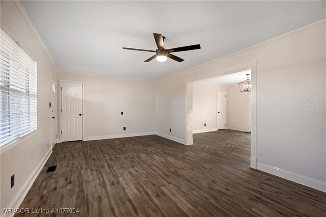 unfurnished room with ceiling fan with notable chandelier, dark hardwood / wood-style flooring, and ornamental molding