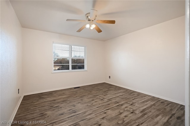 unfurnished room with ceiling fan and dark hardwood / wood-style floors