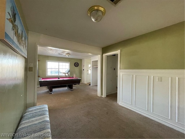 rec room featuring wainscoting, carpet, a decorative wall, and pool table