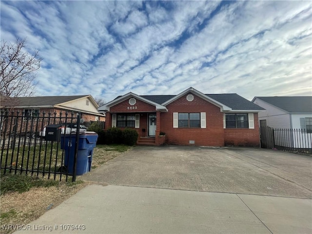 bungalow-style house with crawl space, fence, and brick siding