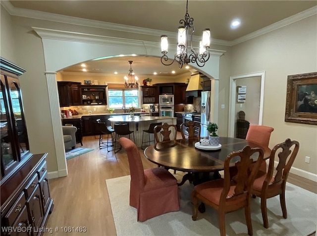 3414 Bugscuffle Rd, Lavaca, AR 72941 - dining room with a chandelier, arched walkways, light wood-style floors, ornamental molding, and recessed lighting