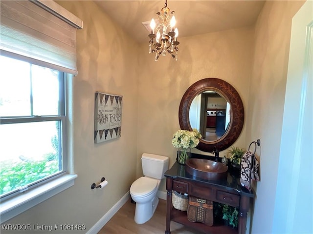 3414 Bugscuffle Rd, Lavaca, AR 72941 - half bathroom featuring a chandelier, healthy amount of natural light, vanity, and wood finished floors