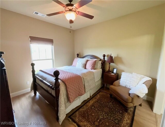 3414 Bugscuffle Rd, Lavaca, AR 72941 - bedroom with wood finished floors and a ceiling fan