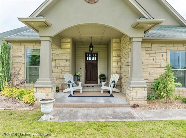 3414 Bugscuffle Rd, Lavaca, AR 72941 - view of exterior entry with a shingled roof, a porch, and stone siding