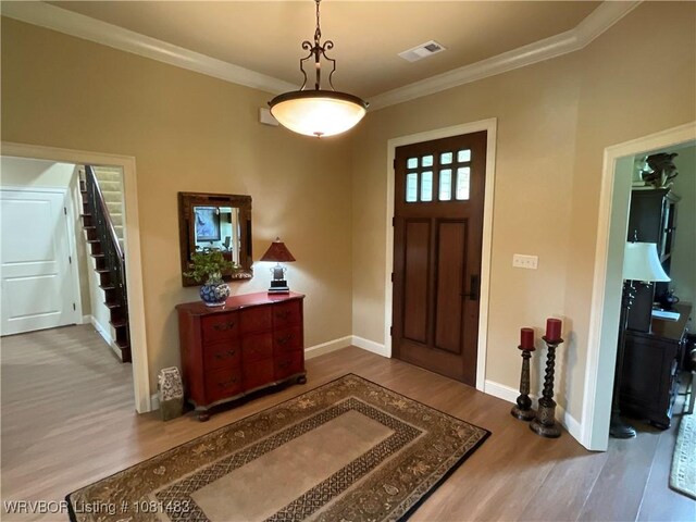 3414 Bugscuffle Rd, Lavaca, AR 72941 - foyer featuring wood finished floors, crown molding, and stairway