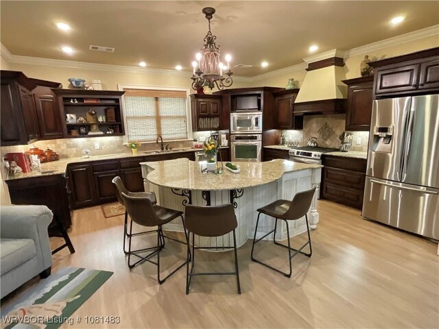 3414 Bugscuffle Rd, Lavaca, AR 72941 - kitchen with stainless steel appliances, premium range hood, a breakfast bar area, tasteful backsplash, and a center island