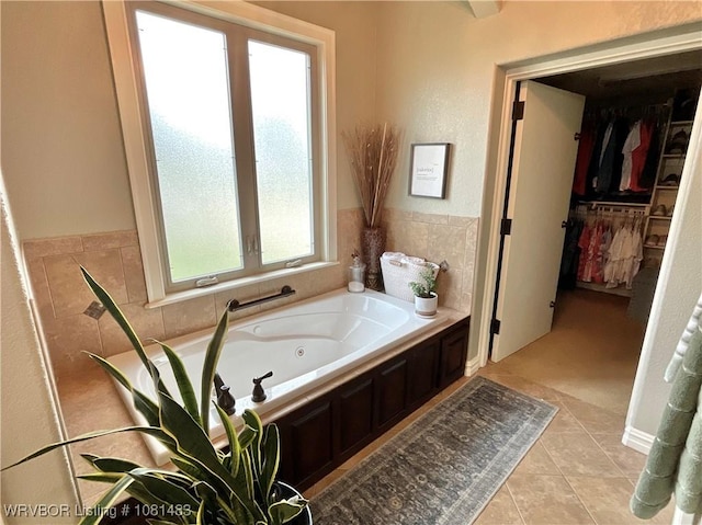 3414 Bugscuffle Rd, Lavaca, AR 72941 - bathroom with a jetted tub, tile patterned floors, and a spacious closet