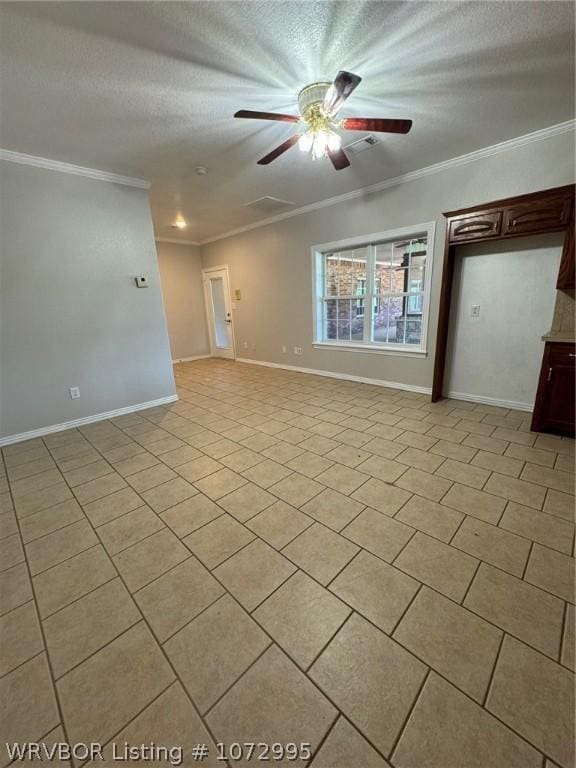 spare room with crown molding, light tile patterned floors, a textured ceiling, and ceiling fan