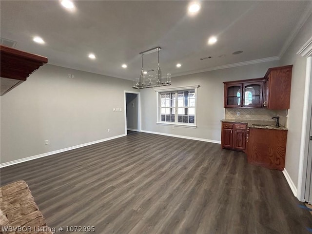 unfurnished living room with dark hardwood / wood-style floors, ornamental molding, and sink