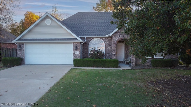 view of front of home with a lawn and a garage