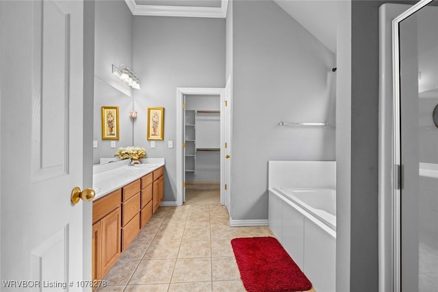 bathroom featuring a garden tub, a spacious closet, a stall shower, vanity, and tile patterned floors