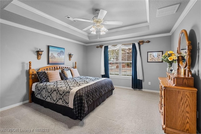 bedroom featuring a tray ceiling, visible vents, light carpet, and baseboards