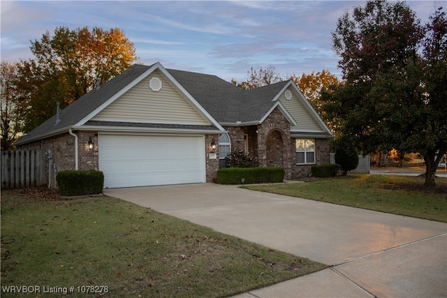 view of front facade with a yard and a garage