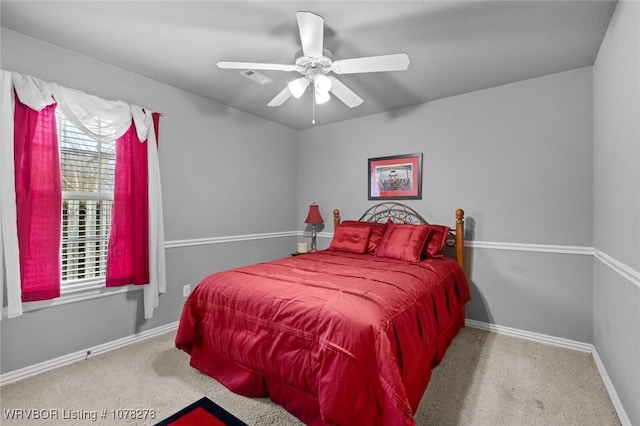 carpeted bedroom with a ceiling fan, visible vents, and baseboards