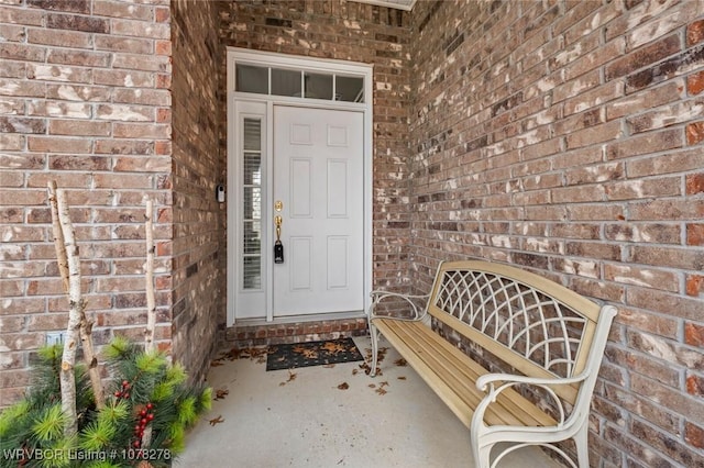 property entrance featuring brick siding