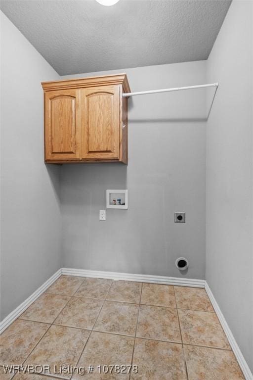 laundry area featuring light tile patterned floors, hookup for a washing machine, cabinet space, electric dryer hookup, and baseboards