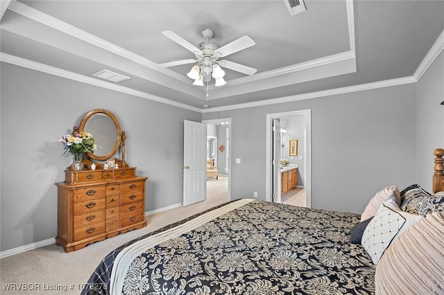 bedroom featuring a tray ceiling, light colored carpet, and visible vents