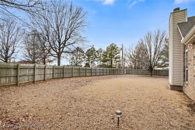 view of yard with a fenced backyard