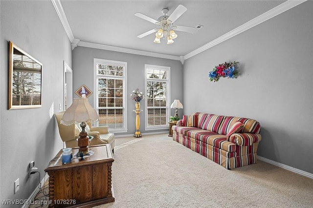 living area featuring carpet floors, crown molding, baseboards, and ceiling fan