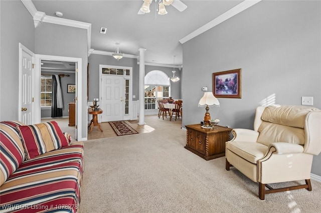 living area featuring ornamental molding, a ceiling fan, visible vents, and light colored carpet