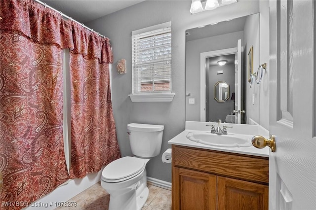 full bath with toilet, tile patterned floors, vanity, baseboards, and shower / tub combo with curtain