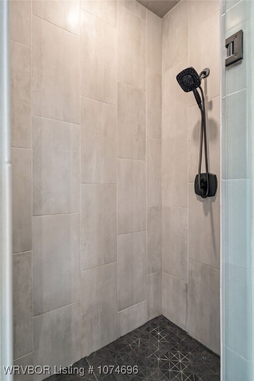 bathroom with a tile shower