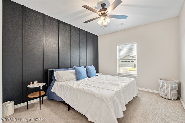 bedroom with light carpet and ceiling fan