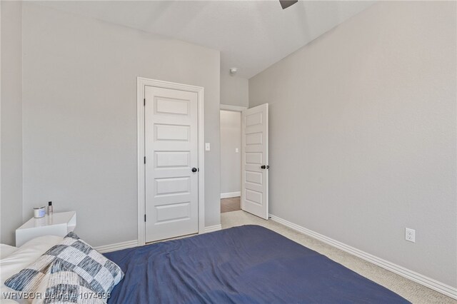 unfurnished bedroom with ceiling fan and light colored carpet