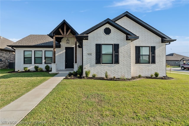 view of front of property with central AC unit and a front yard