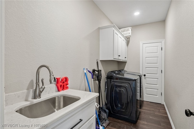 clothes washing area featuring cabinets, washer / clothes dryer, and sink