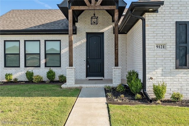 doorway to property with a lawn