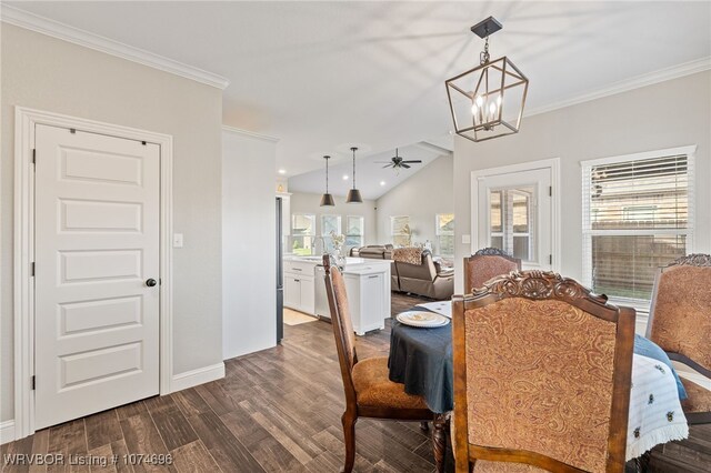 dining room with ornamental molding, ceiling fan with notable chandelier, and lofted ceiling