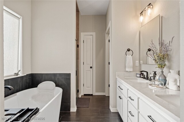 bathroom featuring vanity and a tub