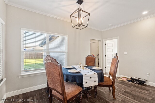 dining room featuring dark hardwood / wood-style floors, plenty of natural light, ornamental molding, and an inviting chandelier