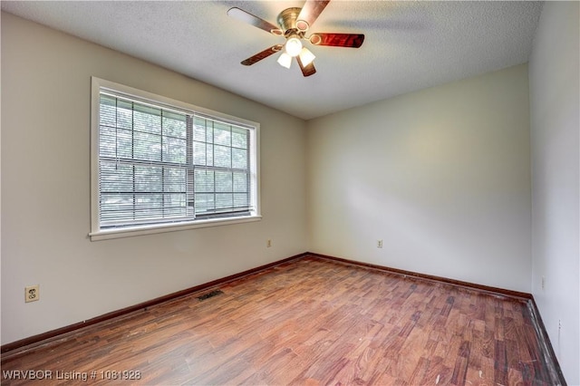 1141 Mountain Grove Ter, Alma, AR 72921 - spare room with wood finished floors, a ceiling fan, and a textured ceiling