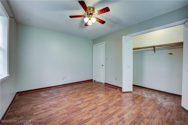 1141 Mountain Grove Ter, Alma, AR 72921 - unfurnished bedroom with wood finished floors, a closet, and a ceiling fan