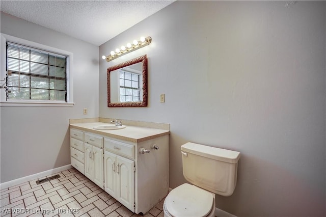1141 Mountain Grove Ter, Alma, AR 72921 - bathroom with plenty of natural light, vanity, brick patterned flooring, and a textured ceiling