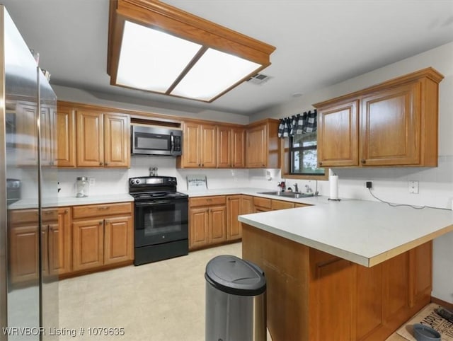 34590 Latam Ridge Rd, Shady Point, OK 74956 - kitchen featuring appliances with stainless steel finishes, a peninsula, a sink, brown cabinetry, and light countertops