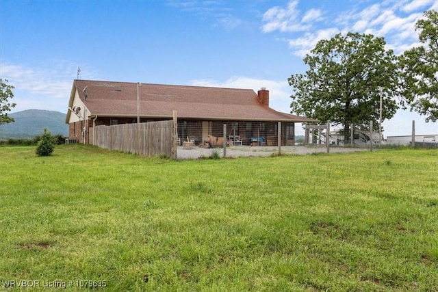 34590 Latam Ridge Rd, Shady Point, OK 74956 - rear view of house featuring a chimney, a mountain view, and a yard